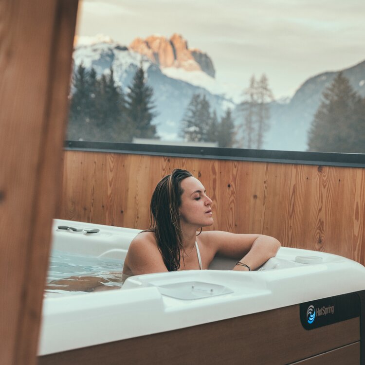 Benessere in Val di Fassa | © Federico Modica - Archivio Immagini ApT Val di Fassa Persona nella vasca idromassaggio esterna con vista sulle Dolomiti innevate in Val di Fassa | © Federico Modica - Archivio Immagini ApT Val di Fassa